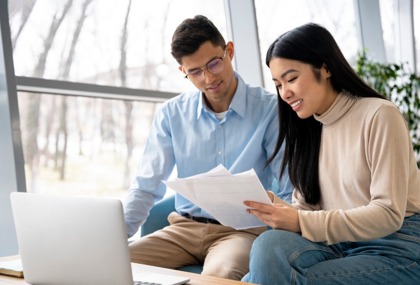 students reviewing education funding documents showing how income share agreements work for college tuition