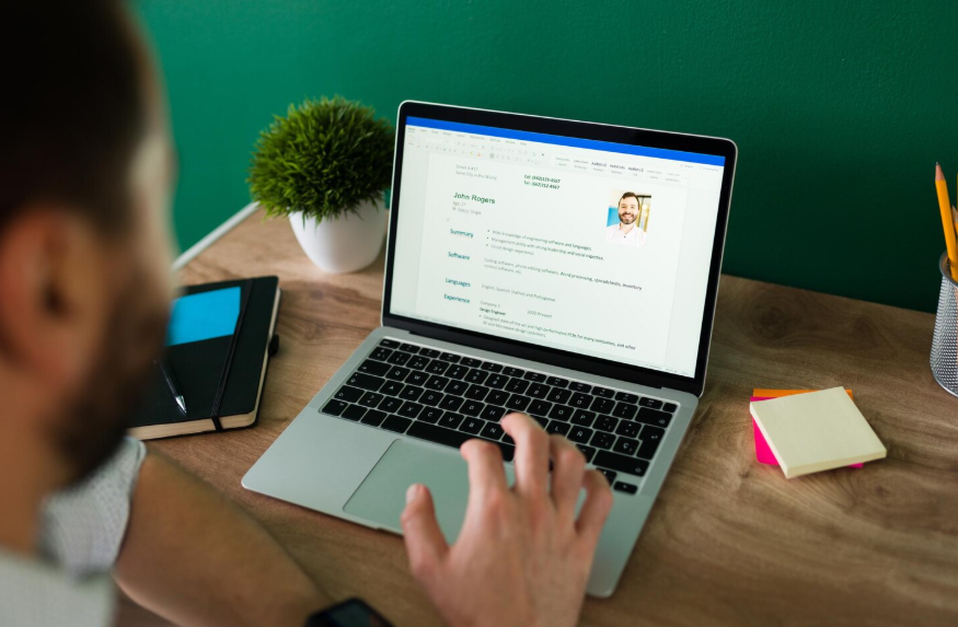 student using laptop to build a resume while still in college with practical experience and skills