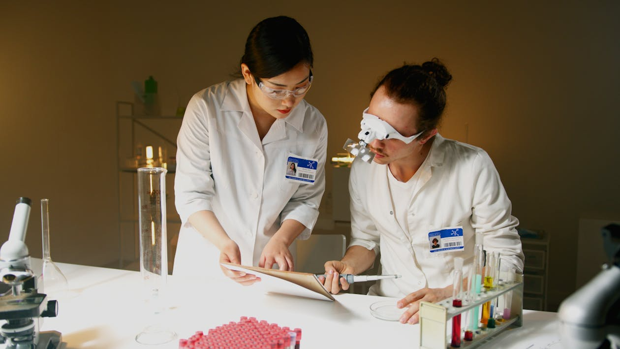 college students conducting undergraduate research in a university lab analyzing data and experiments