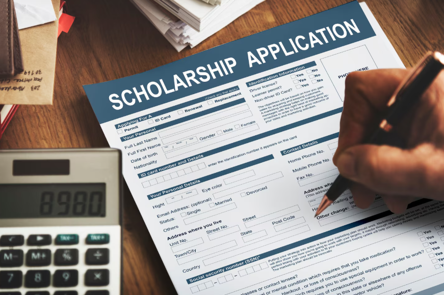 student completing scholarship form while comparing grants vs scholarships differences